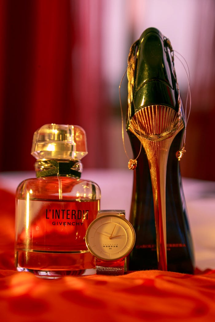 Elegant display of luxury perfume, watch, and high heel shoe in Abidjan.